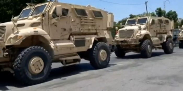 A stalled convoy of armored vehicles in Port Au Prince Haiti PHOTO